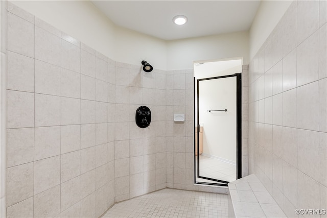 bathroom featuring tile patterned floors and a tile shower