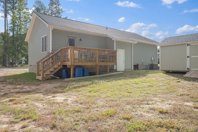 back of house with a yard, a deck, a shed, and central AC unit