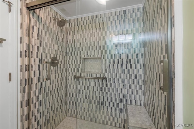 bathroom with a shower with door and ornamental molding