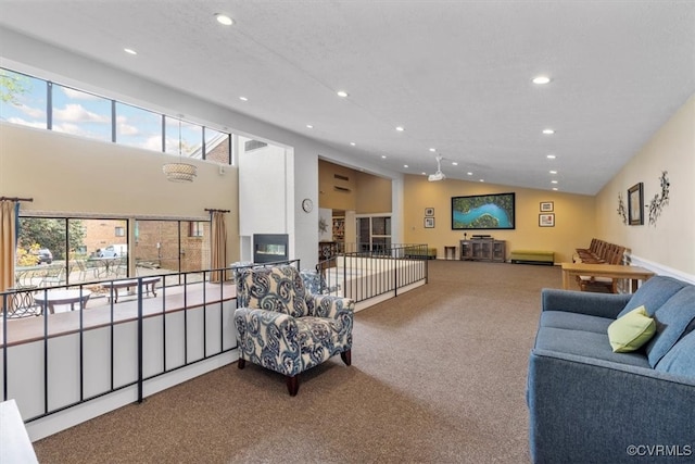 carpeted living room with high vaulted ceiling and plenty of natural light