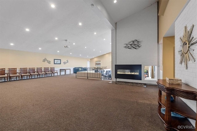 carpeted living room with high vaulted ceiling