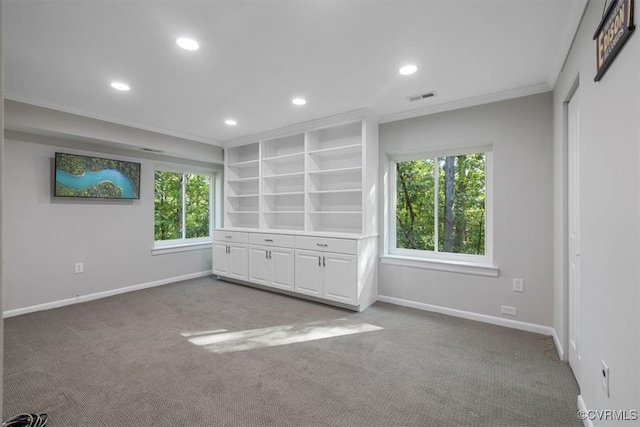 interior space featuring crown molding and light colored carpet