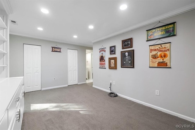 interior space featuring recessed lighting, ornamental molding, carpet flooring, and visible vents