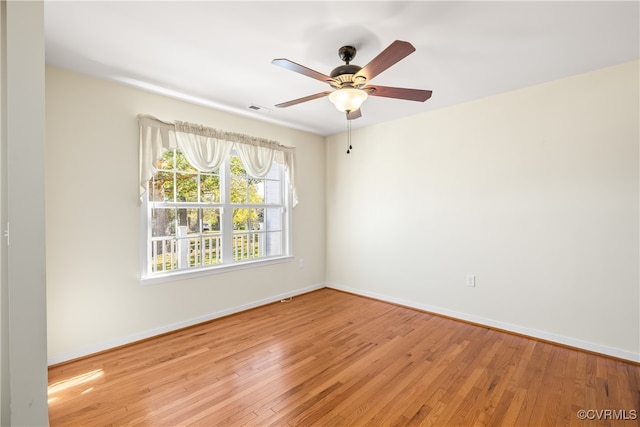 spare room featuring light hardwood / wood-style flooring and ceiling fan