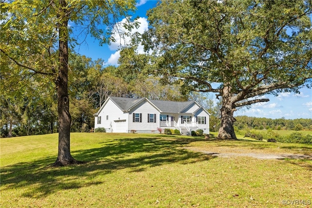 view of front of home with covered porch, a garage, and a front lawn