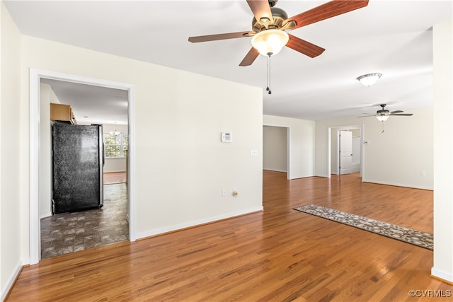 unfurnished room featuring hardwood / wood-style flooring and ceiling fan