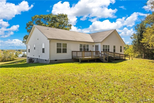 rear view of house with a wooden deck, a yard, and central AC unit