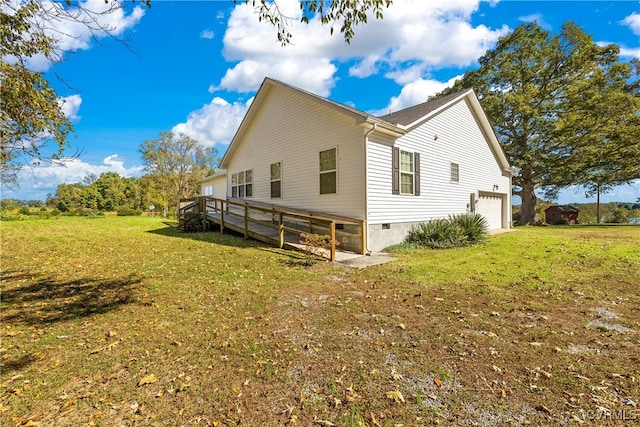 view of side of home featuring a yard and a deck