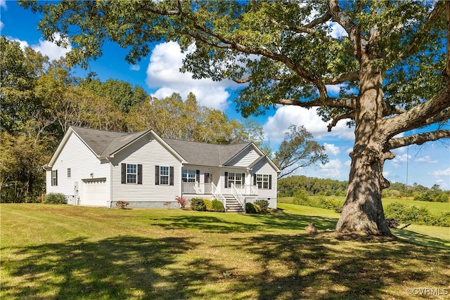 view of front of house featuring a porch, a front lawn, and a garage