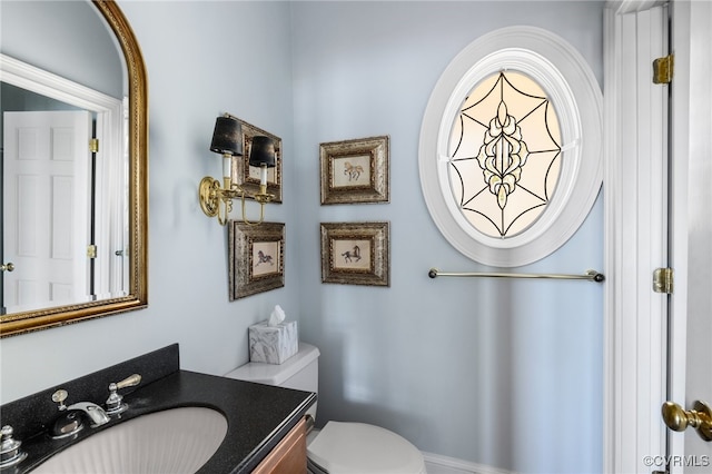 bathroom featuring vanity and toilet