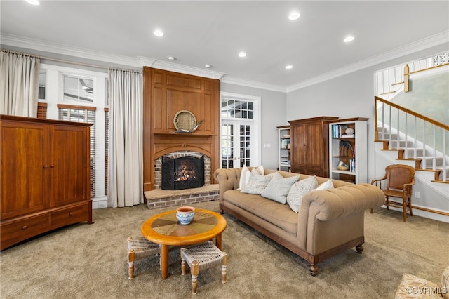 carpeted living room featuring crown molding and a fireplace