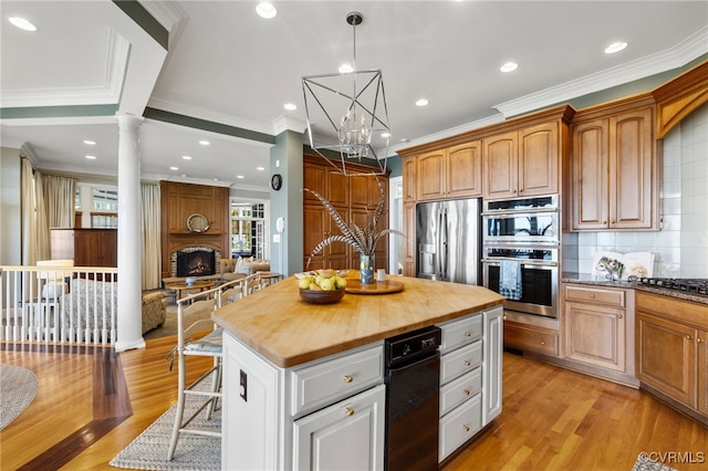 kitchen with a kitchen island, butcher block counters, backsplash, decorative columns, and light wood-type flooring