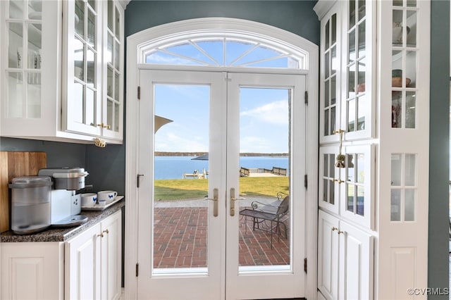 entryway with french doors and a water view