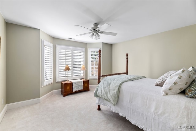 bedroom featuring light carpet and ceiling fan