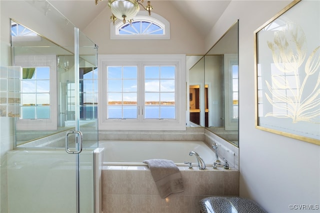 bathroom with lofted ceiling, a water view, and separate shower and tub