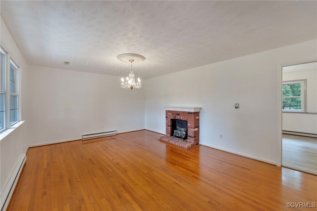 unfurnished living room with a baseboard radiator and hardwood / wood-style floors