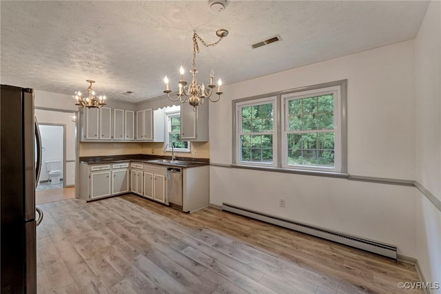 kitchen featuring baseboard heating, pendant lighting, light hardwood / wood-style flooring, and stainless steel appliances