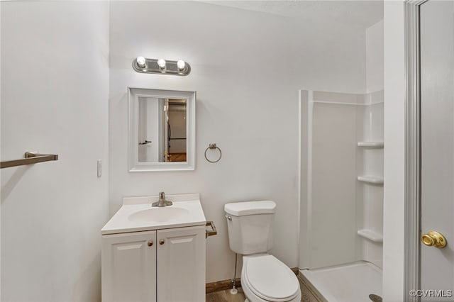 bathroom with vanity, toilet, and a shower