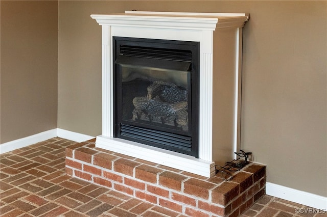 details featuring a brick fireplace