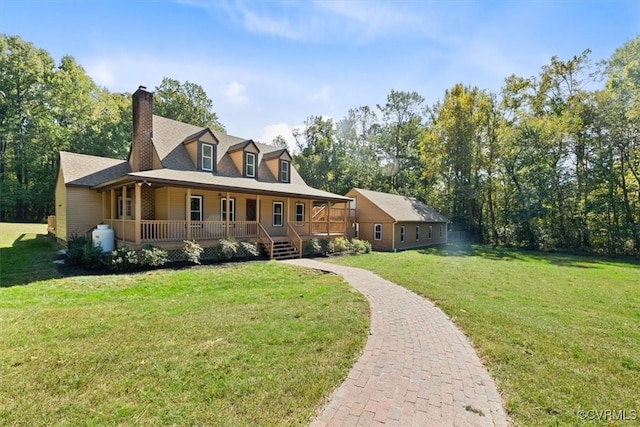 rear view of house featuring covered porch and a lawn