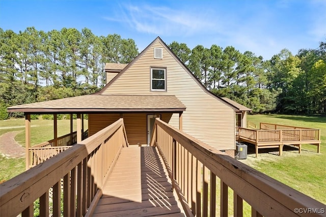 exterior space with a yard, a deck, and central AC unit