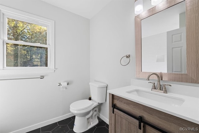 bathroom with vanity, toilet, and tile patterned flooring