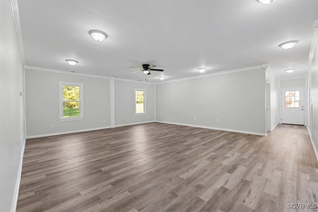 spare room with light hardwood / wood-style floors, crown molding, and ceiling fan