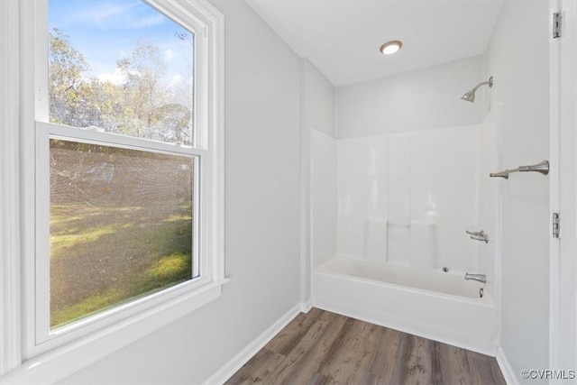 bathroom featuring shower / bathing tub combination and hardwood / wood-style floors