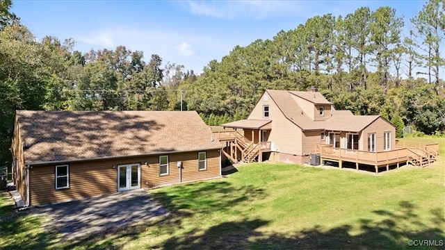 back of property with a yard, a deck, and central air condition unit