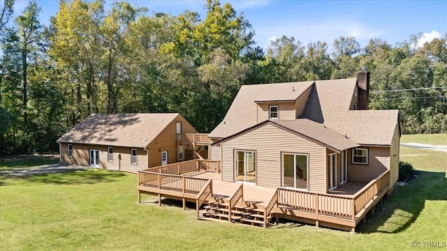 back of property with a wooden deck and a lawn