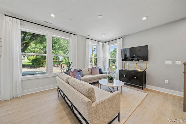 living area featuring baseboards, recessed lighting, visible vents, and light wood-style floors