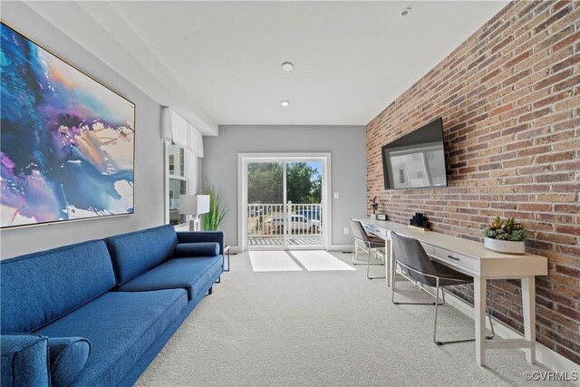 home office with baseboards, light colored carpet, and brick wall