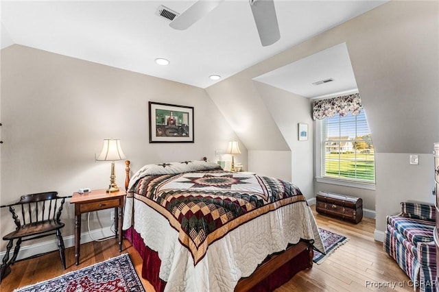 bedroom with ceiling fan, wood-type flooring, and lofted ceiling