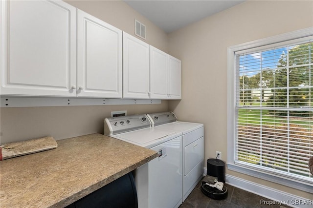 330 River Village Dr, Weems, VA 22576 - laundry room with cabinet space, washing machine and clothes dryer, healthy amount of natural light, and tile patterned floors