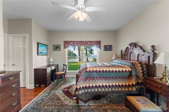 bedroom featuring ceiling fan and dark hardwood / wood-style floors