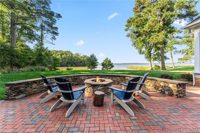 view of patio / terrace featuring a water view and an outdoor fire pit