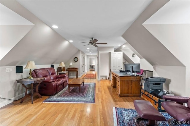 interior space featuring ceiling fan, light wood-type flooring, and vaulted ceiling