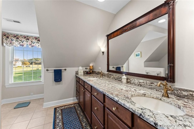 bathroom with tile patterned floors, vanity, and lofted ceiling