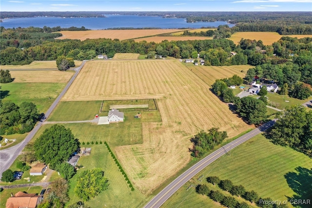 birds eye view of property with a water view and a rural view