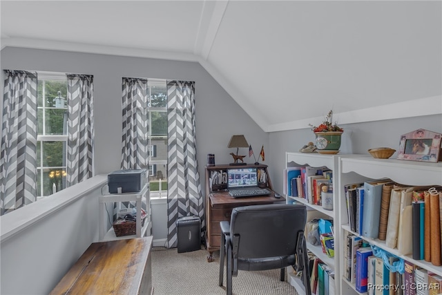 carpeted home office featuring vaulted ceiling