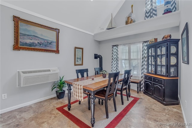 dining room with a wall mounted air conditioner, a wood stove, and high vaulted ceiling