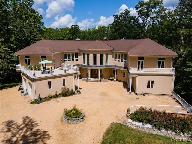 back of house featuring a balcony