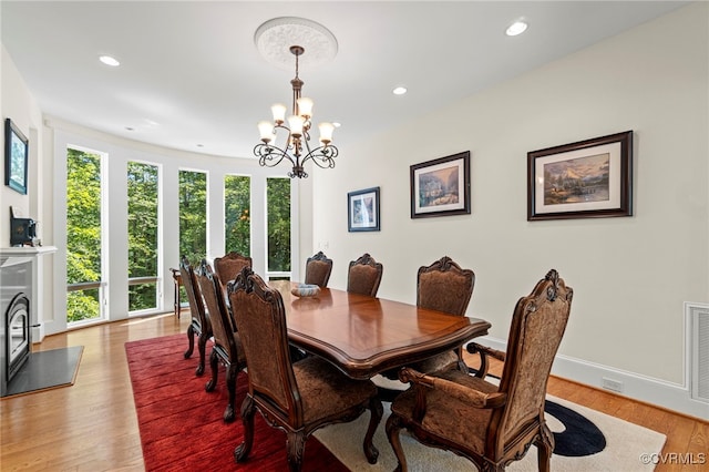 dining room with a chandelier and light hardwood / wood-style flooring