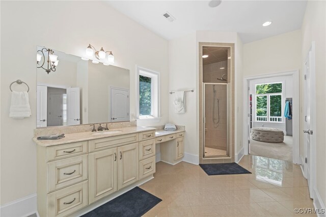 bathroom with tile patterned flooring, a shower with shower door, vanity, and a healthy amount of sunlight