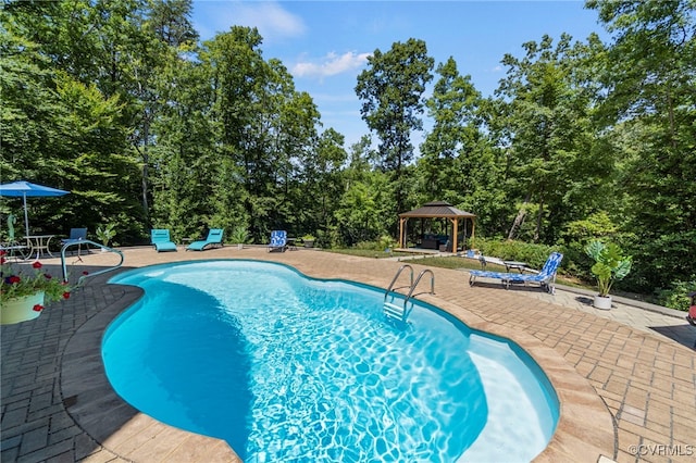 view of swimming pool featuring a patio and a gazebo