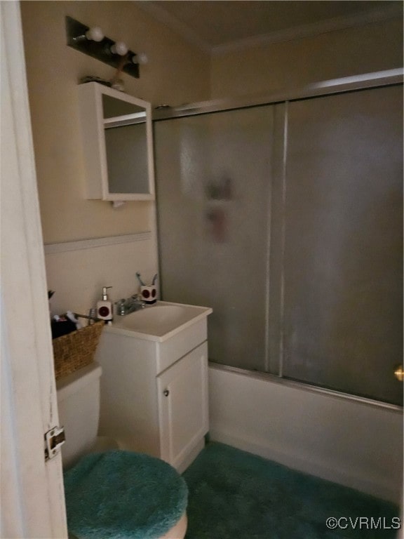 full bathroom with vanity, toilet, combined bath / shower with glass door, and ornamental molding