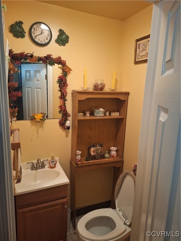 bathroom featuring toilet and vanity