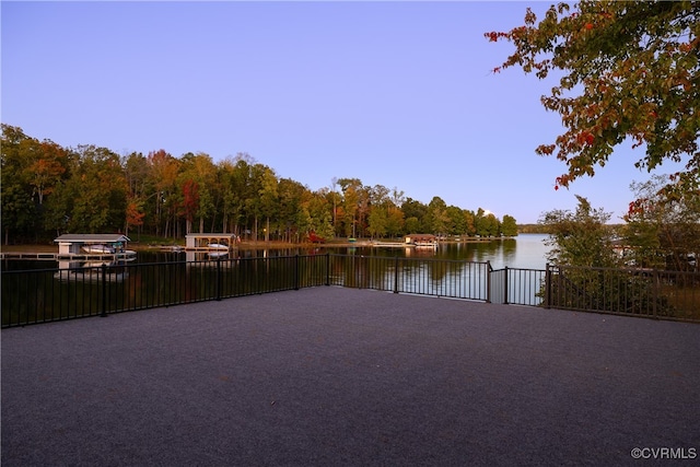 property view of water featuring a dock and a forest view