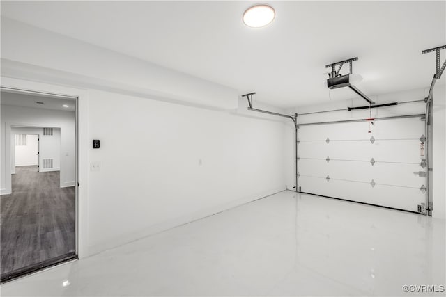 garage featuring a garage door opener and visible vents