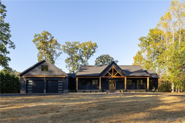 view of front of home with a garage, driveway, and french doors